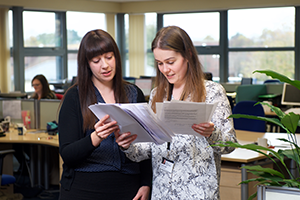 Hyde employees reading papers