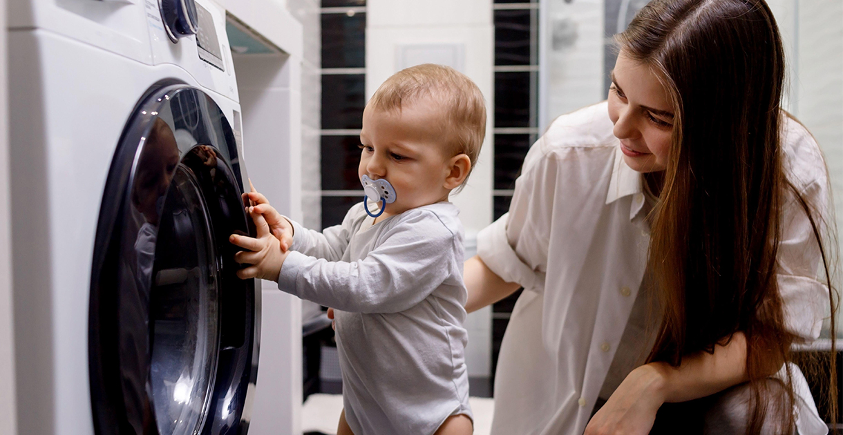 Young Woman And Baby Washing Machine SEO