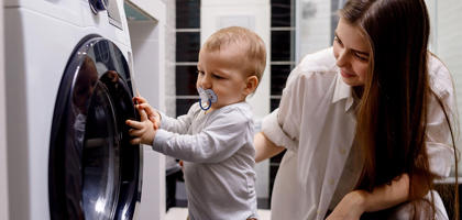 Young Woman And Baby Washing Machine SEO