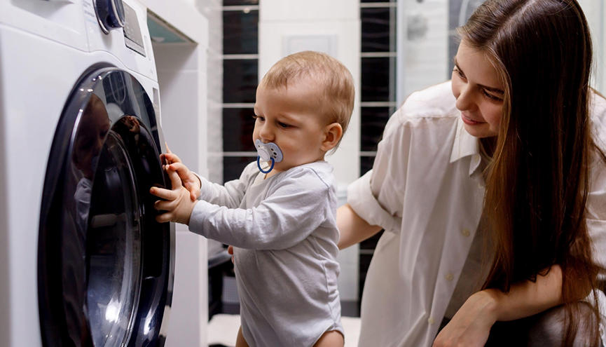 Young Woman And Baby Washing Machine SEO