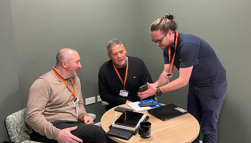 Mark, Neal and Tom looking at mobile - 1220x630