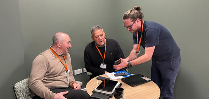 Mark, Neal and Tom looking at mobile - 1220x630