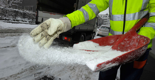 Picture of someone in a high vis jacket spreading grit